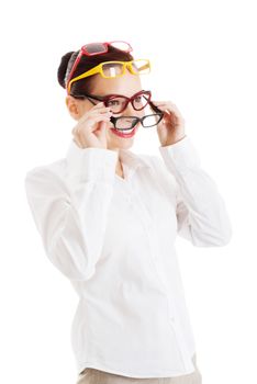 Beautiful woman wearing four different pairs of eyeglasses. Isolated on white.