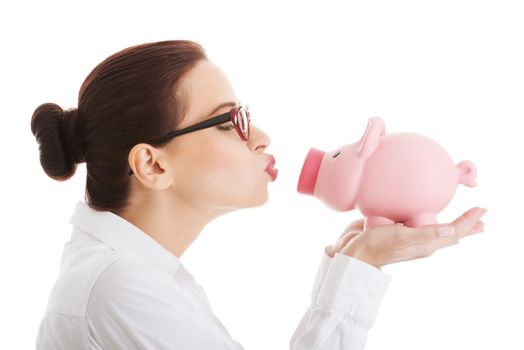 Beautiful business woman holding piggy-bank. Isolated on white.