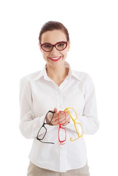 Beautiful woman in eyeglasses holding three different pair of eyeglasses. Isolated on white.