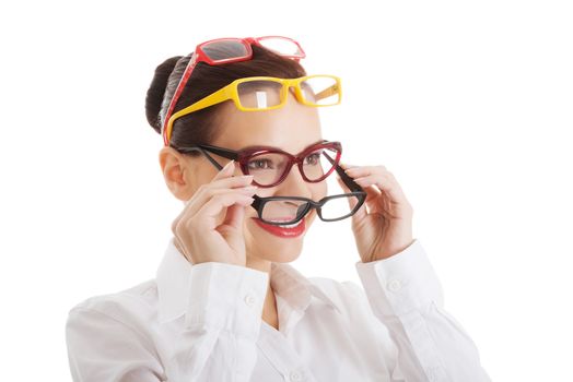 Beautiful woman wearing four different pairs of eyeglasses. Isolated on white.