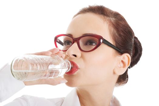 Beautiful business woman with plastic bottle of water. Isolated on white.