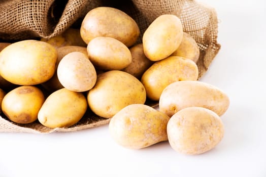Fresh potatoes. Over white background.