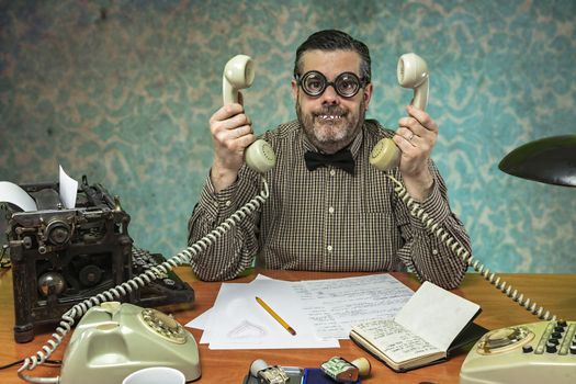 Employee with glasses talking on the phone in the office in the 1960s