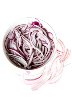 Composition of red onion rings in a bowl. Isolated on white.