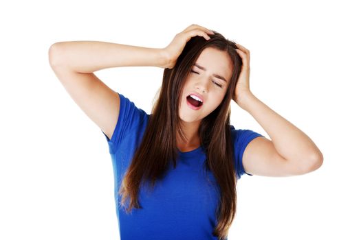 Young beautiful woman having terrible headache. Isolated on white.