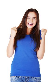 Happy young casual woman with closed fists. Isolated on white.