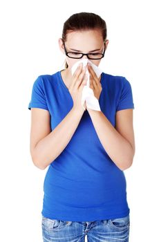 Young casual woman with tissue. Isolated on white.