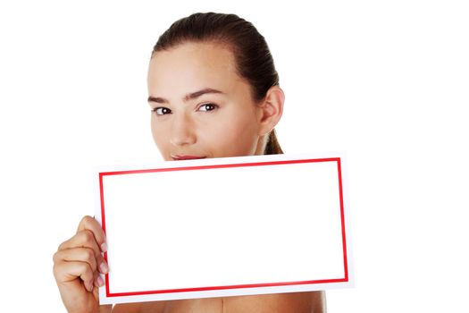 Young beautiful casual woman holding copy space. Isolated on white.