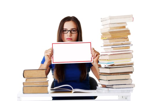 Beautiful young woman stuydent wih stack of books and holding copy space. Isolated on white.