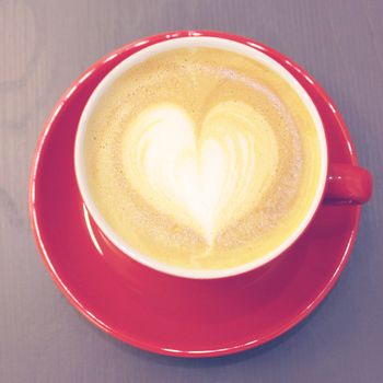 Cappuccino or latte coffee with heart shape, retro filter effect 