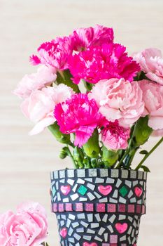 Carnation in mosaic flower pot