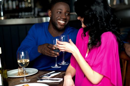 Young happy amorous couple toasting champagne