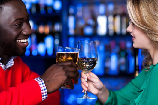 Young romantic couple enjoying cocktails in nightclub