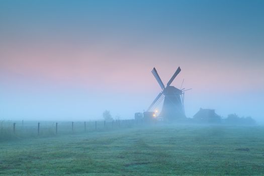 Dutch windmill in fog at sunrise, Groningen, Netherlands