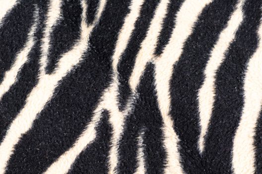 A rug shaped in zebra stripes in full frame take