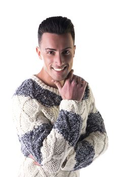 Good looking young man with winter sweater, touching chin with his hand