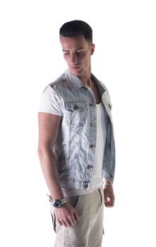 Attractive young man with jeans gilet (vest) and white t-shirt and pants