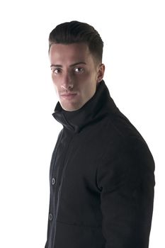 Profile shot of handsome young man with winter coat looking at camera, isolated on white