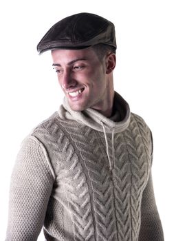 Handsome young man smiling, wearing knitted wool white sweater and leather hat