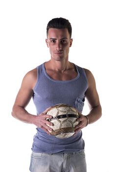 Handsome young man in tanktop holding soccer ball, looking at camera, isolated on white