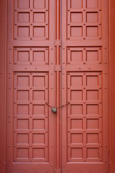 A brown vintage ornate decorative timber door in Grand Palace, Thailand