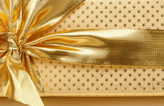 close up detail of golden ribbon on luxury gift