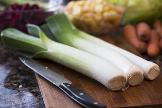 Leeks on cutting board with knife