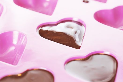 Close up of warm chocolate that has just been poured into a heart mould
