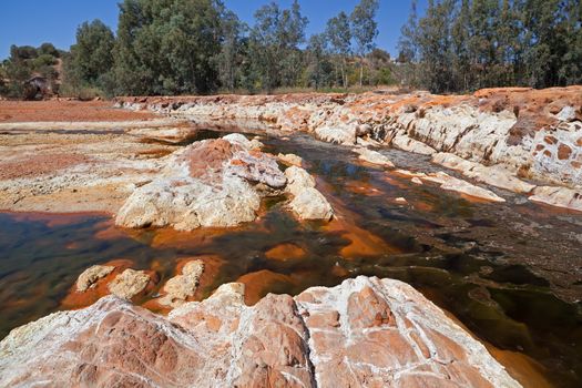orange stones in acidic rio Tinto, Niebla (Huelva), Spain