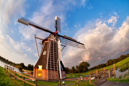 Dutch windmill over blue sky, fish-eye view