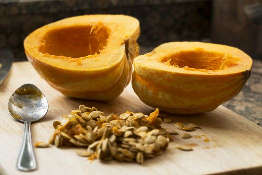 Winter squash cut in half with spoon and seeds scooped out.