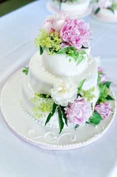 wedding cake with multi levels and pink roses