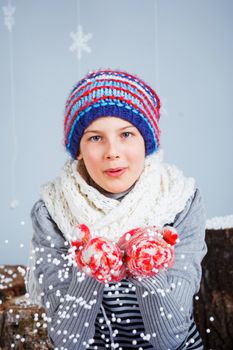 Winter Fashion. Adorable happy fashion girl in winter hat gloves and sweater in studio.