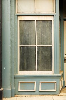 Old dirty window on old blue wall