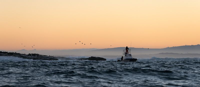 Boating at sunset in Atlantic ocean, South Africa