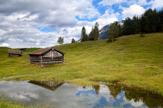 old wooden hut by lake in Alps, Bavaria, Germany
