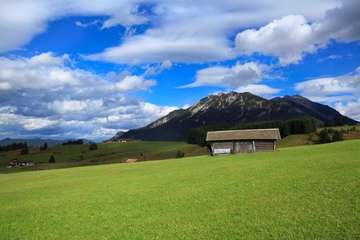 wooden huts on green meadows in Alps, Germany
