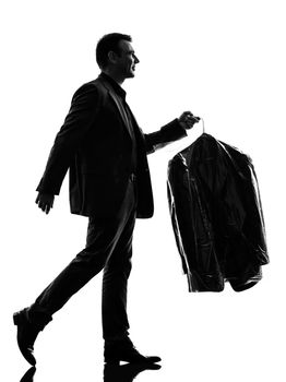 one caucasian business man holding dry clean clothes in silhouette  on white background