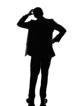 one caucasian business man thinking rear view back in silhouette  on white background