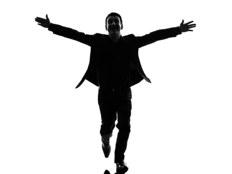 one caucasian business man arms outstretched in silhouette  on white background