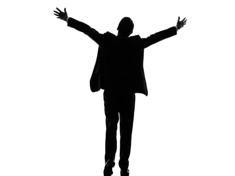 one caucasian business man rear view back arms outstretched in silhouette on white background