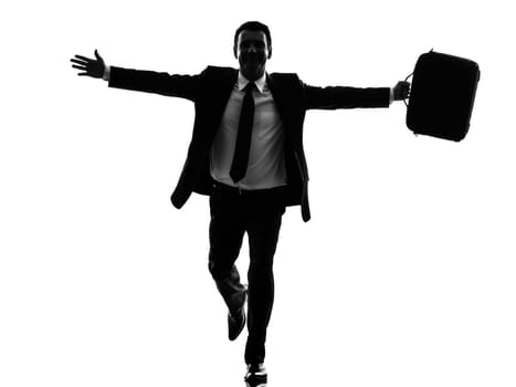 one caucasian business man running happy arms outstretched in silhouette  on white background