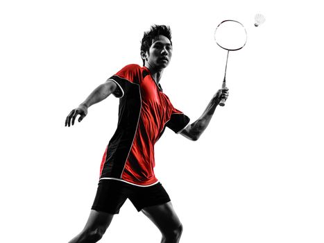 one asian badminton player young man  in silhouette isolated white background