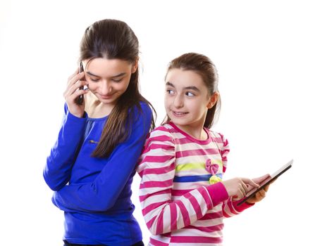 Happy teen girls with digital tablet and smartphone on white background