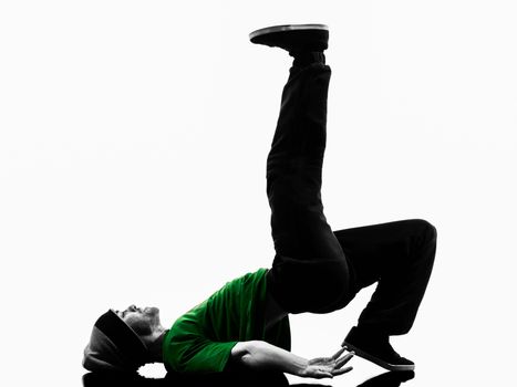 one caucasian young acrobatic break dancer breakdancing man in silhouette  white background