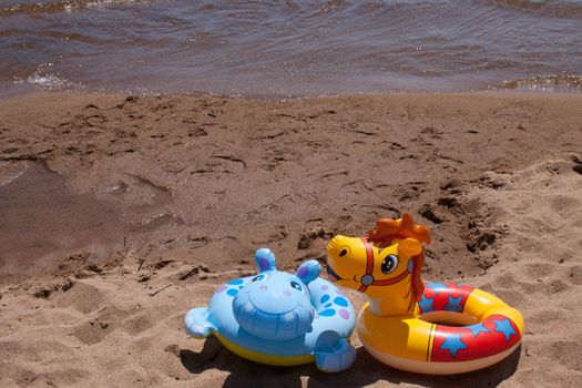 Children's floating toys on the beach.