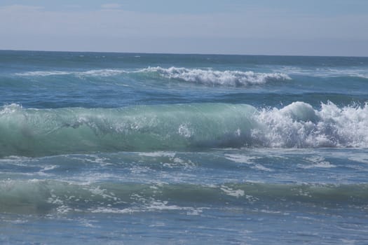 Ocean waves crashing to shore on a lovely summer day.