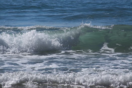 Ocean waves crashing to shore on a lovely summer day.