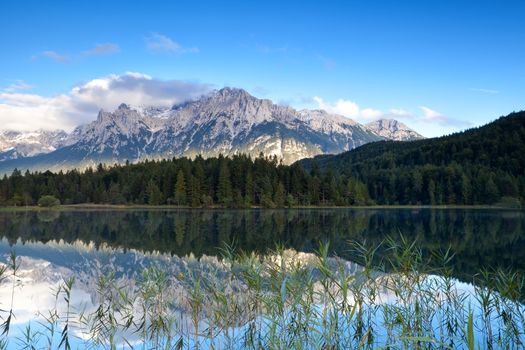 Karwendel mountain range reflected in Lautersee lake, Germany