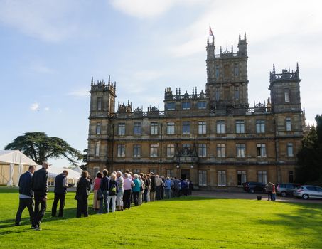 NEWBURY, UK - CIRCA OCTOBER 2011: People  queuing to visit Highclere Castle which  is the main setting for the ITV period drama Downton Abbey.